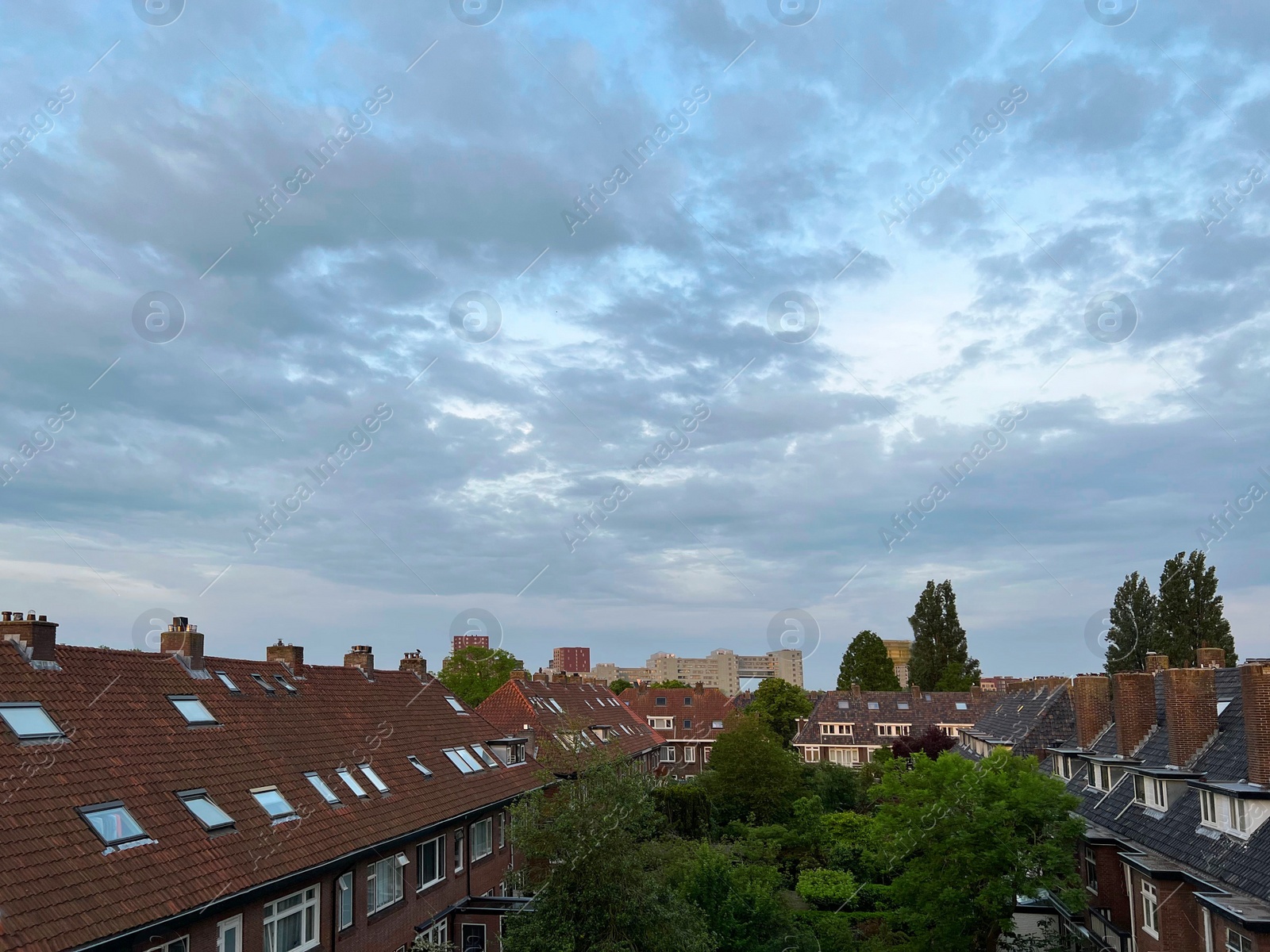 Photo of Picturesque view of city street with beautiful buildings on cloudy day