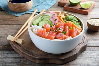 Photo of Delicious poke bowl with salmon and vegetables served on wooden table