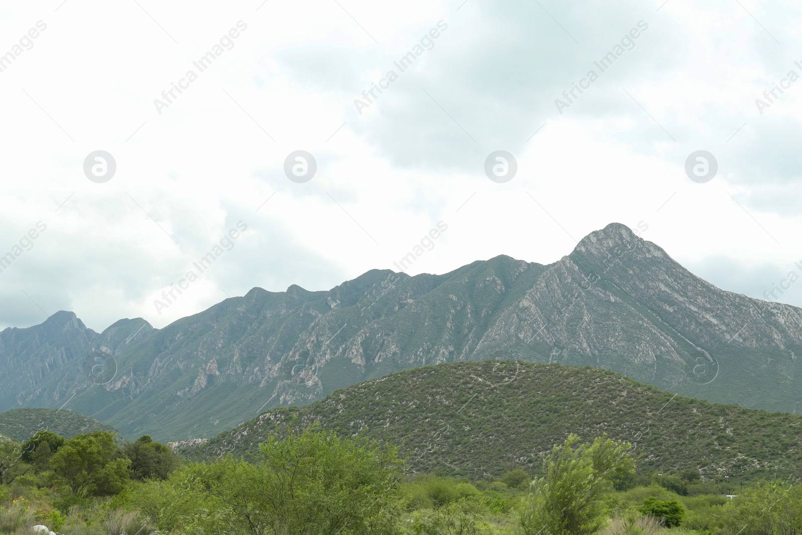 Photo of Picturesque landscape with high mountains and fog under cloudy sky