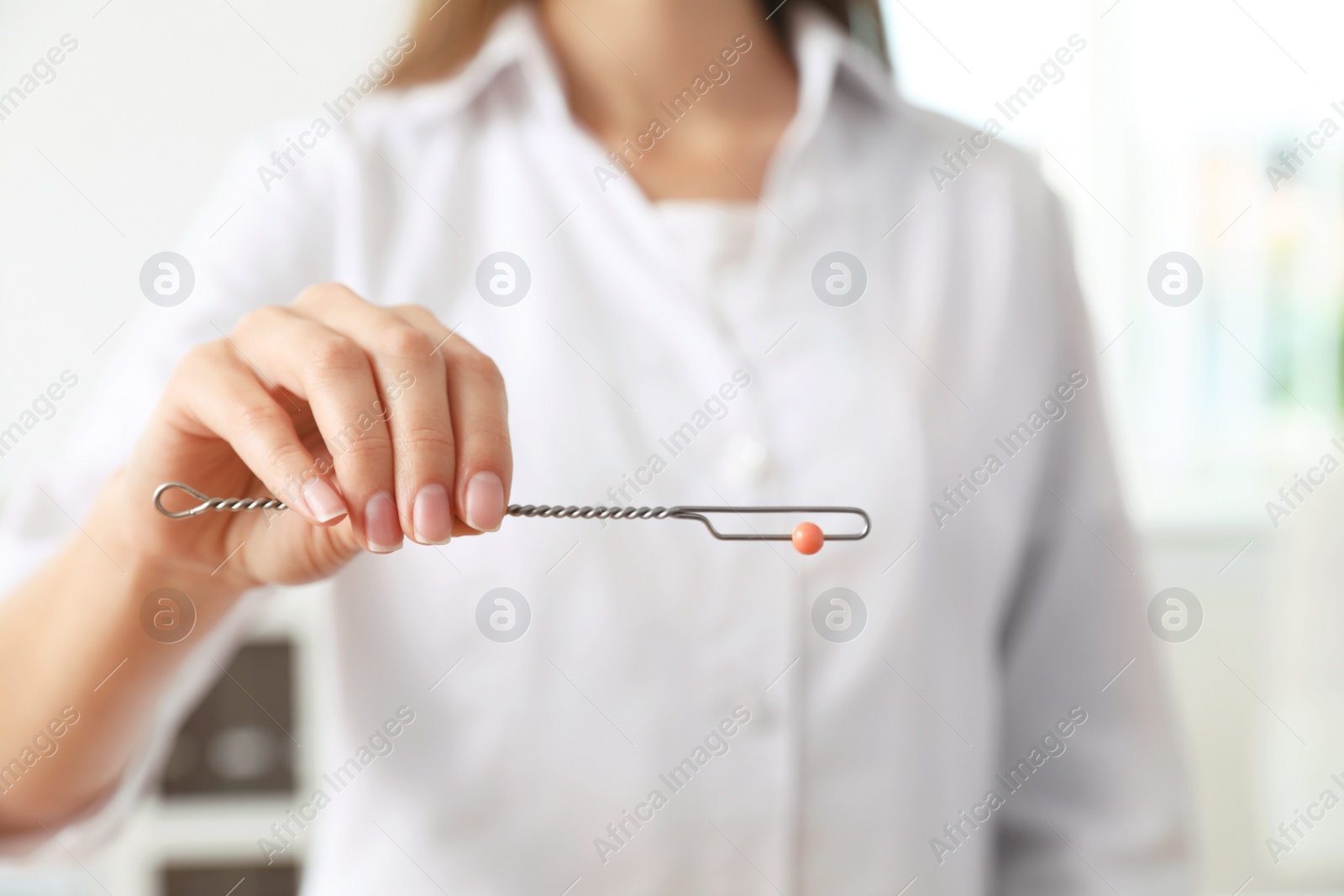 Photo of Speech therapist with logopedic probe in clinic, closeup