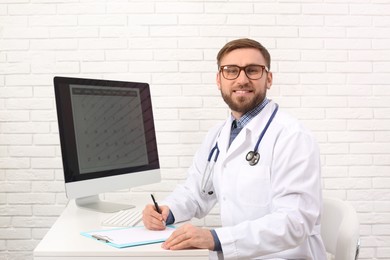 Photo of Portrait of pediatrician at table in clinic