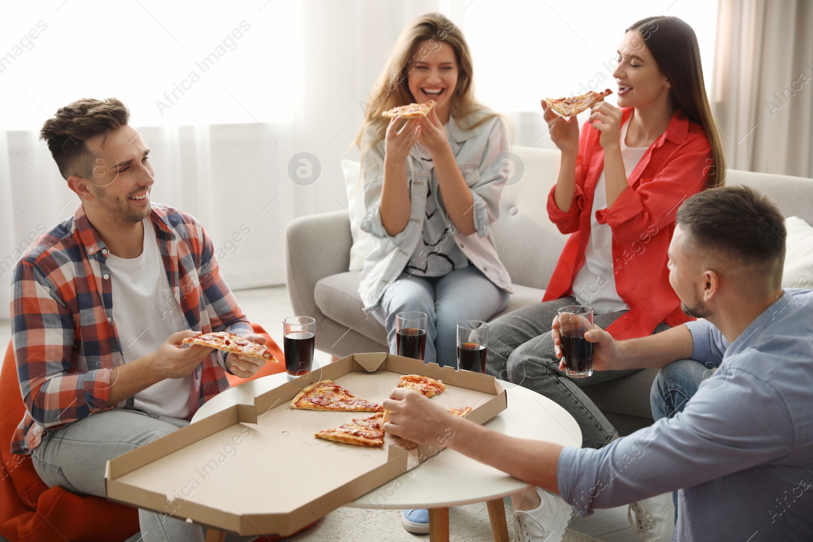 Photo of Group of friends eating tasty pizza at home