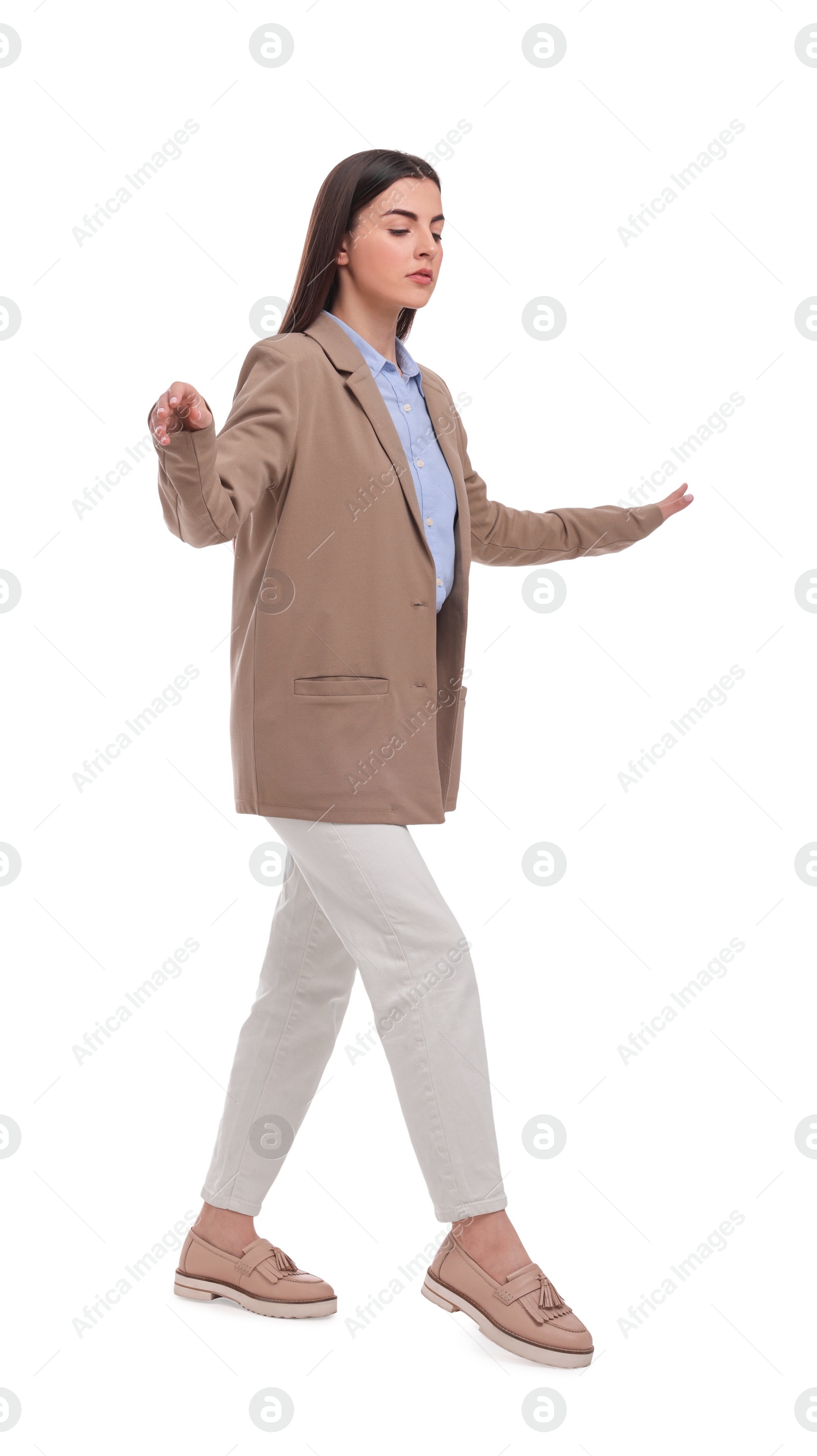 Photo of Beautiful young businesswoman walking on white background