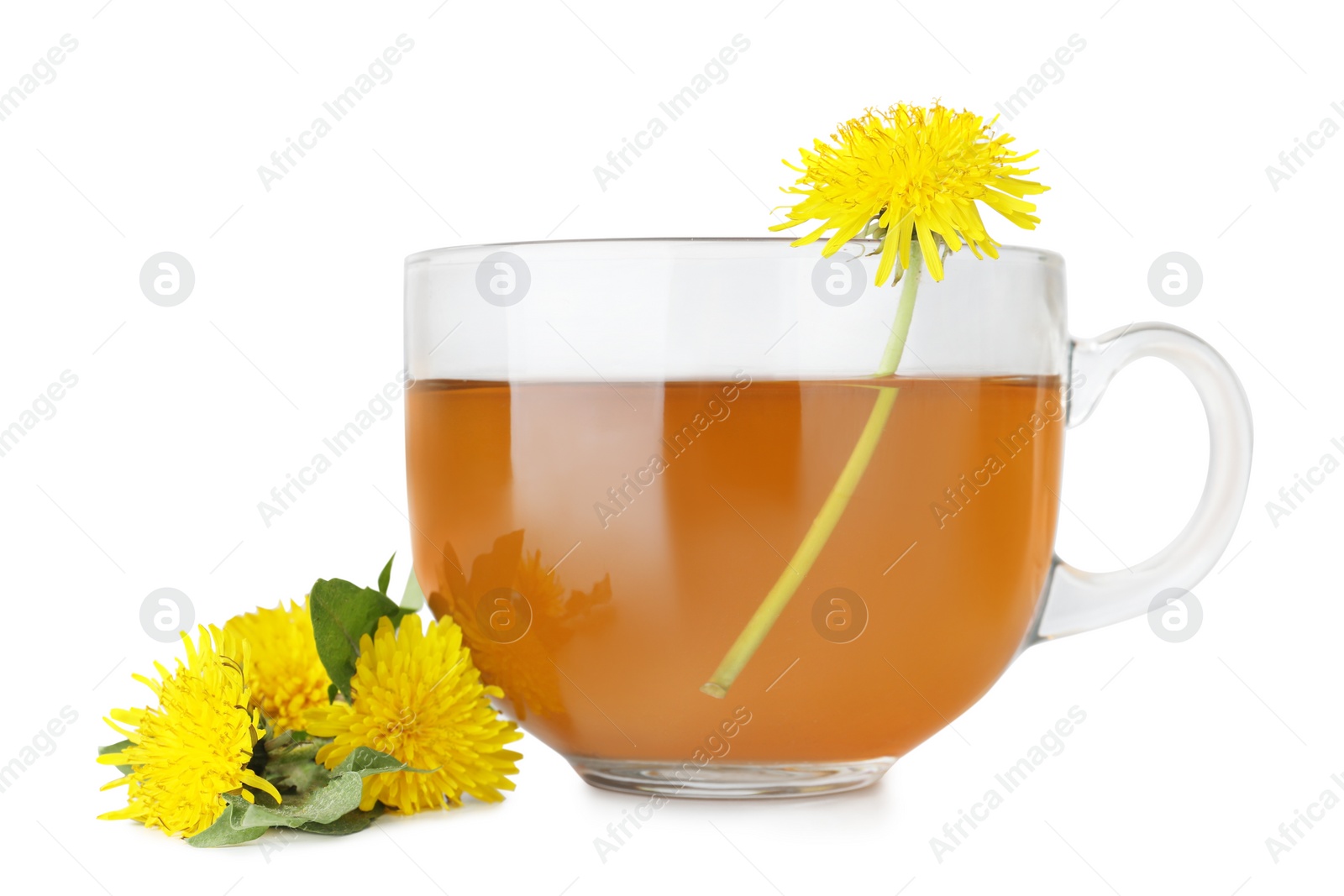 Photo of Delicious fresh tea and beautiful dandelion flowers on white table