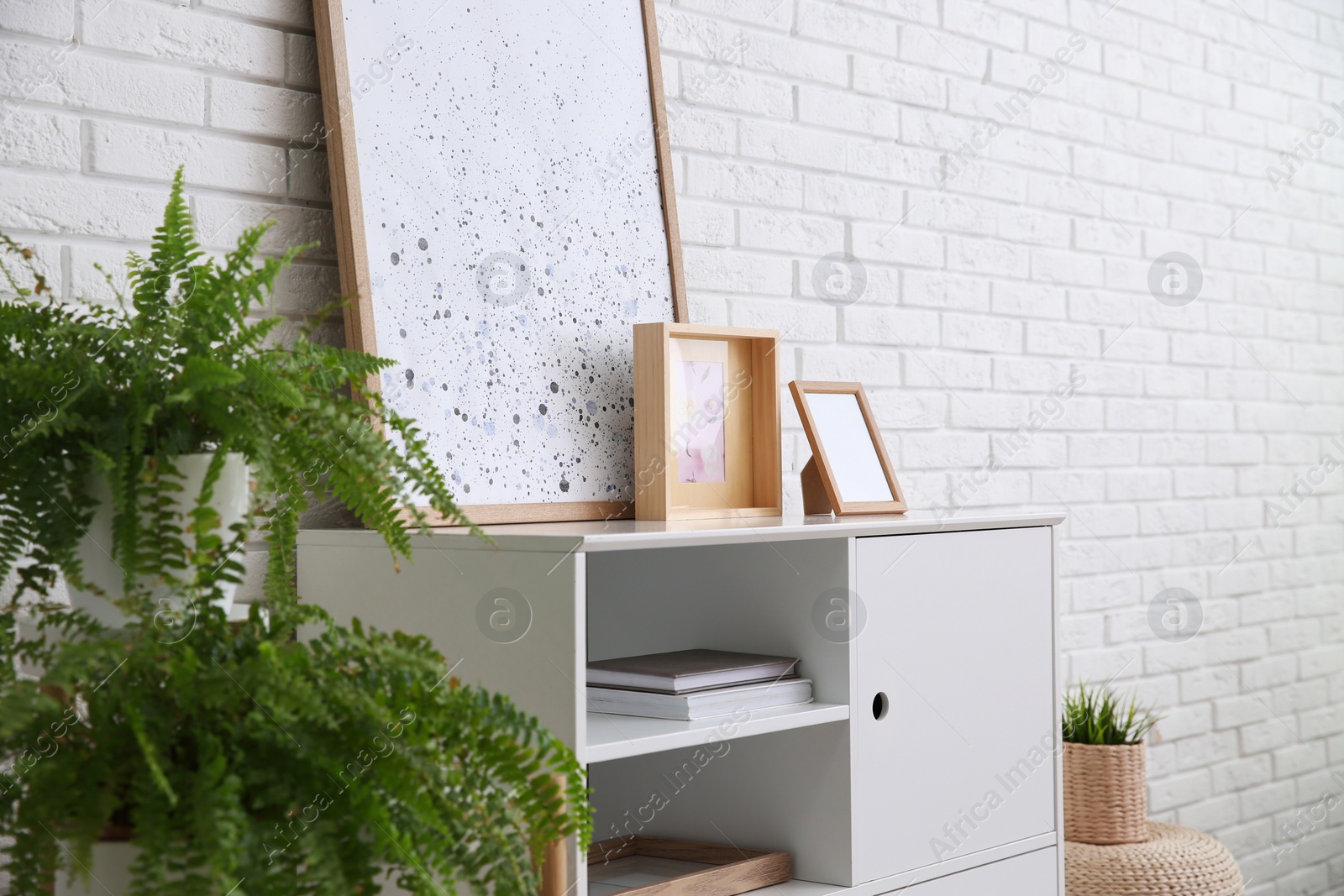 Photo of Modern room interior with stylish white cabinet