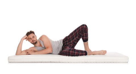 Man lying on soft mattress against white background
