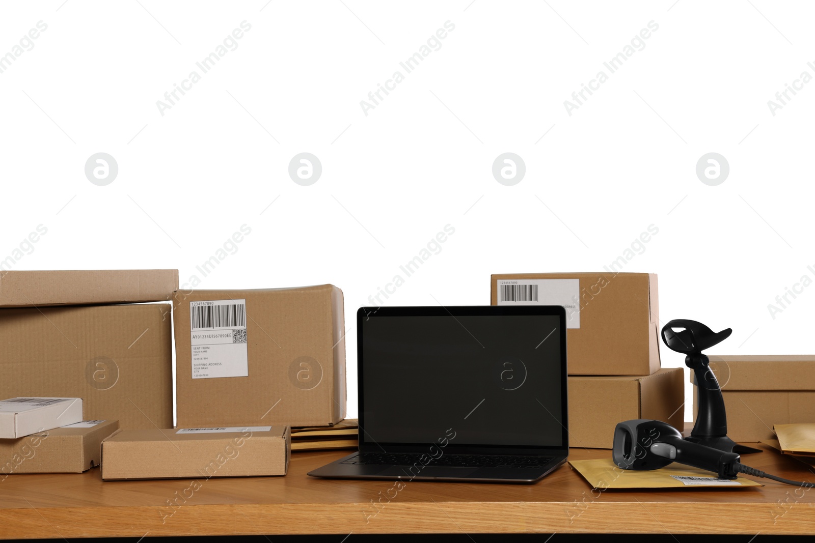 Photo of Parcels, laptop and barcode scanner on wooden table against white background. Online store