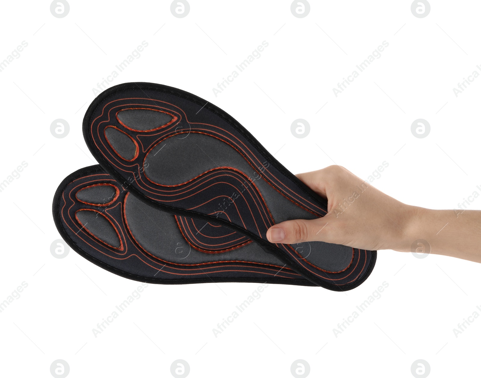 Photo of Woman holding pair of orthopedic insoles on white background, closeup