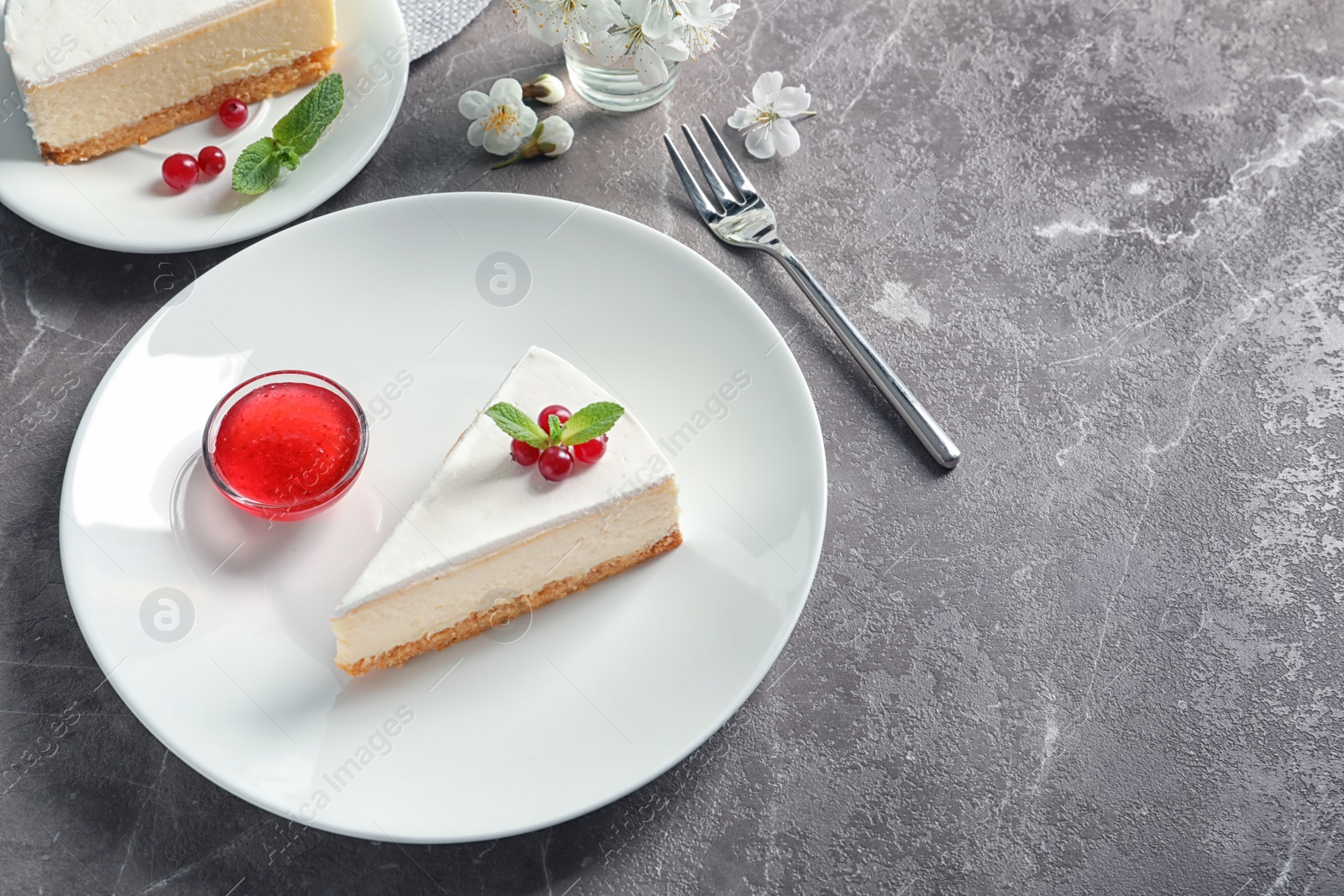 Photo of Delicious cheesecake served with sweet jam on plate