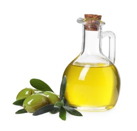 Glass jug of cooking oil, ripe olives and green leaves isolated on white