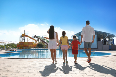 Photo of Family at water park, back view.  Summer vacation