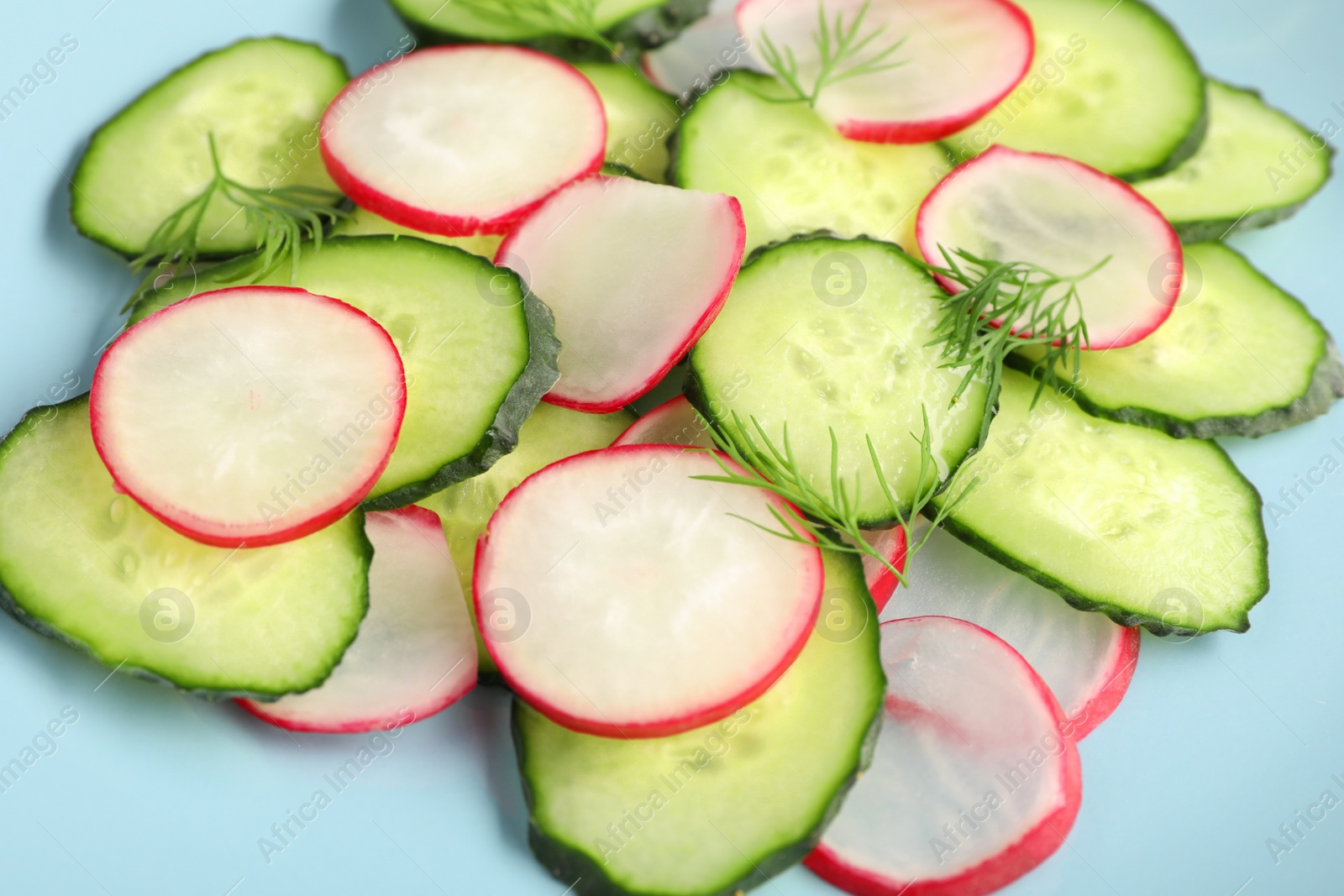 Photo of Tasty salad cucumber and radish, closeup view