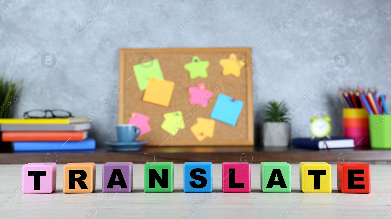 Photo of Word Translate made of colorful cubes with letters on white wooden table