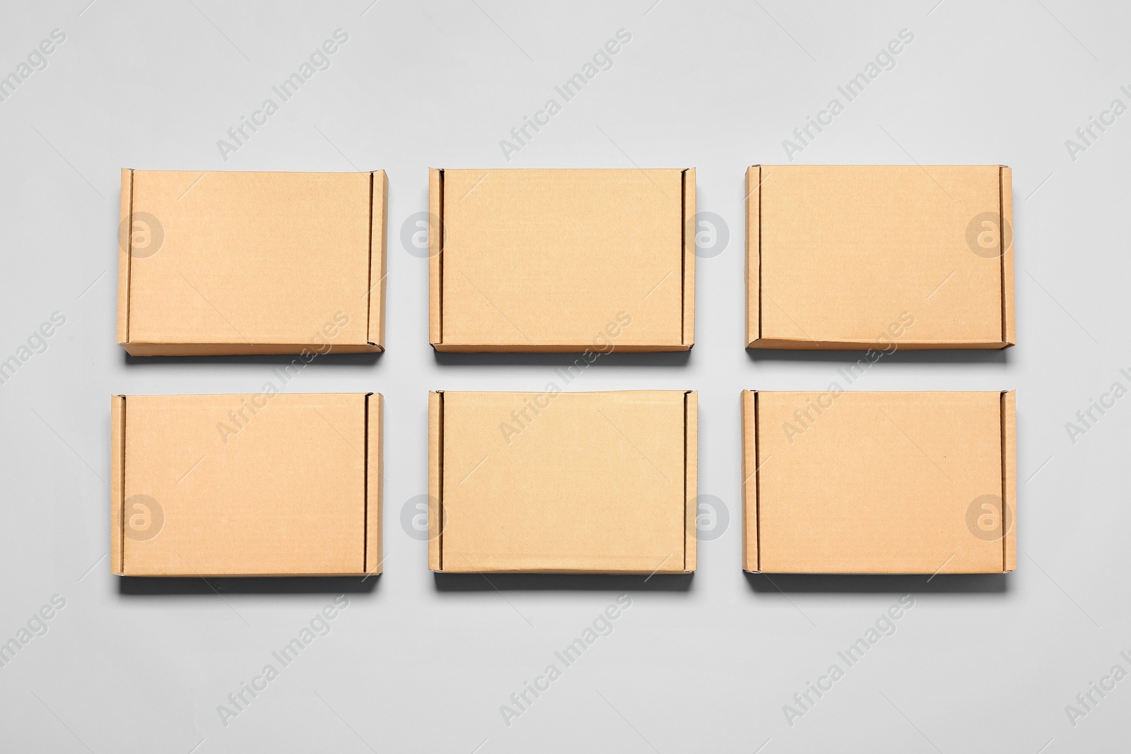 Photo of Many cardboard boxes on white background, flat lay. Packaging goods