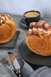 Photo of Crunchy round croissants served on grey table. Tasty puff pastry