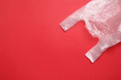 Photo of One plastic bag on red background, top view. Space for text