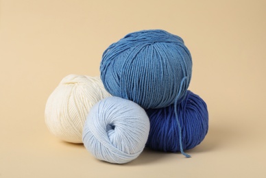 Soft colorful woolen yarns on beige background