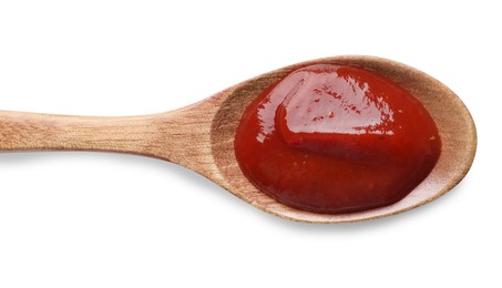 Photo of Tasty ketchup in wooden spoon on white background, top view