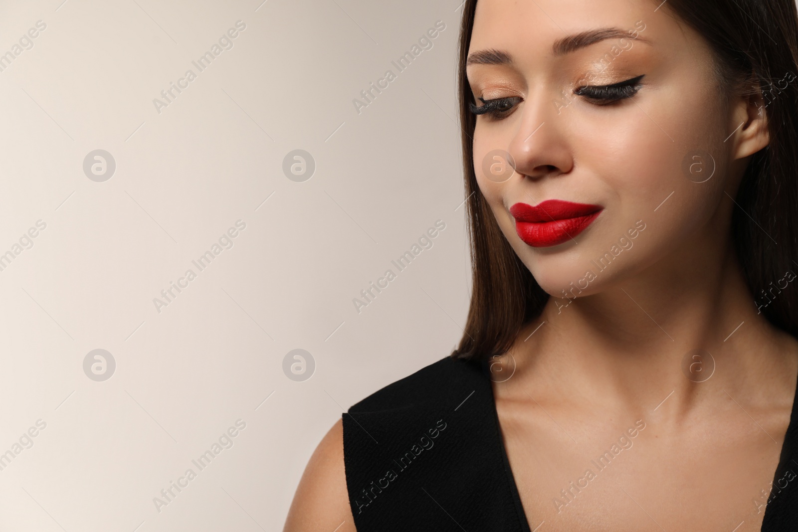 Photo of Beautiful woman with red lipstick on light background, space for text