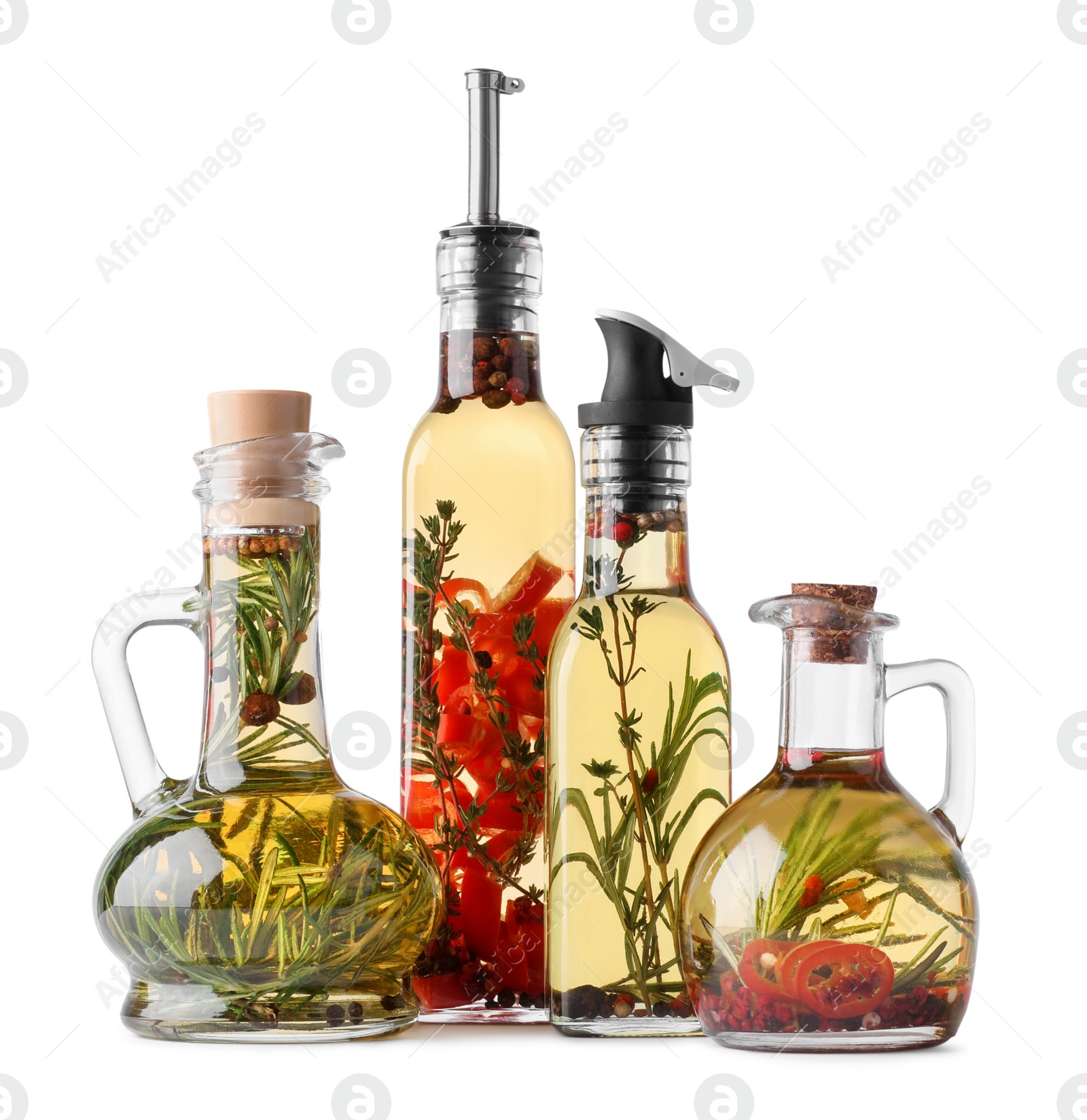 Photo of Different sorts of cooking oil with spices and herbs in bottles on white background