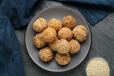 Photo of Delicious sesame balls on grey table, flat lay