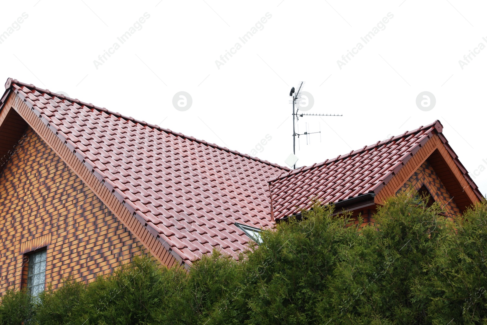 Photo of Beautiful house with red roof against blue sky