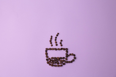 Cup made of coffee beans on lilac background, flat lay