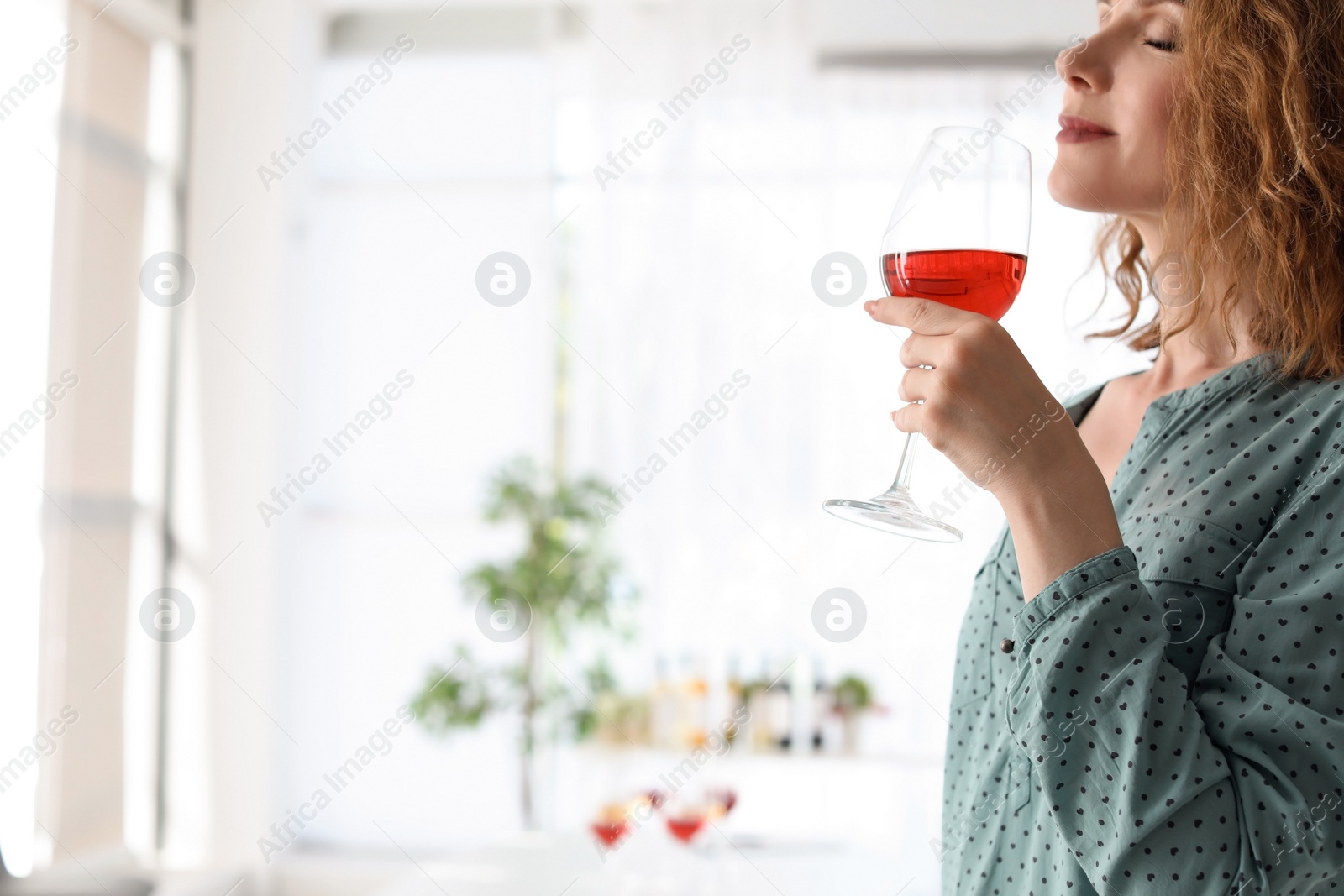 Photo of Woman with glass of delicious wine indoors