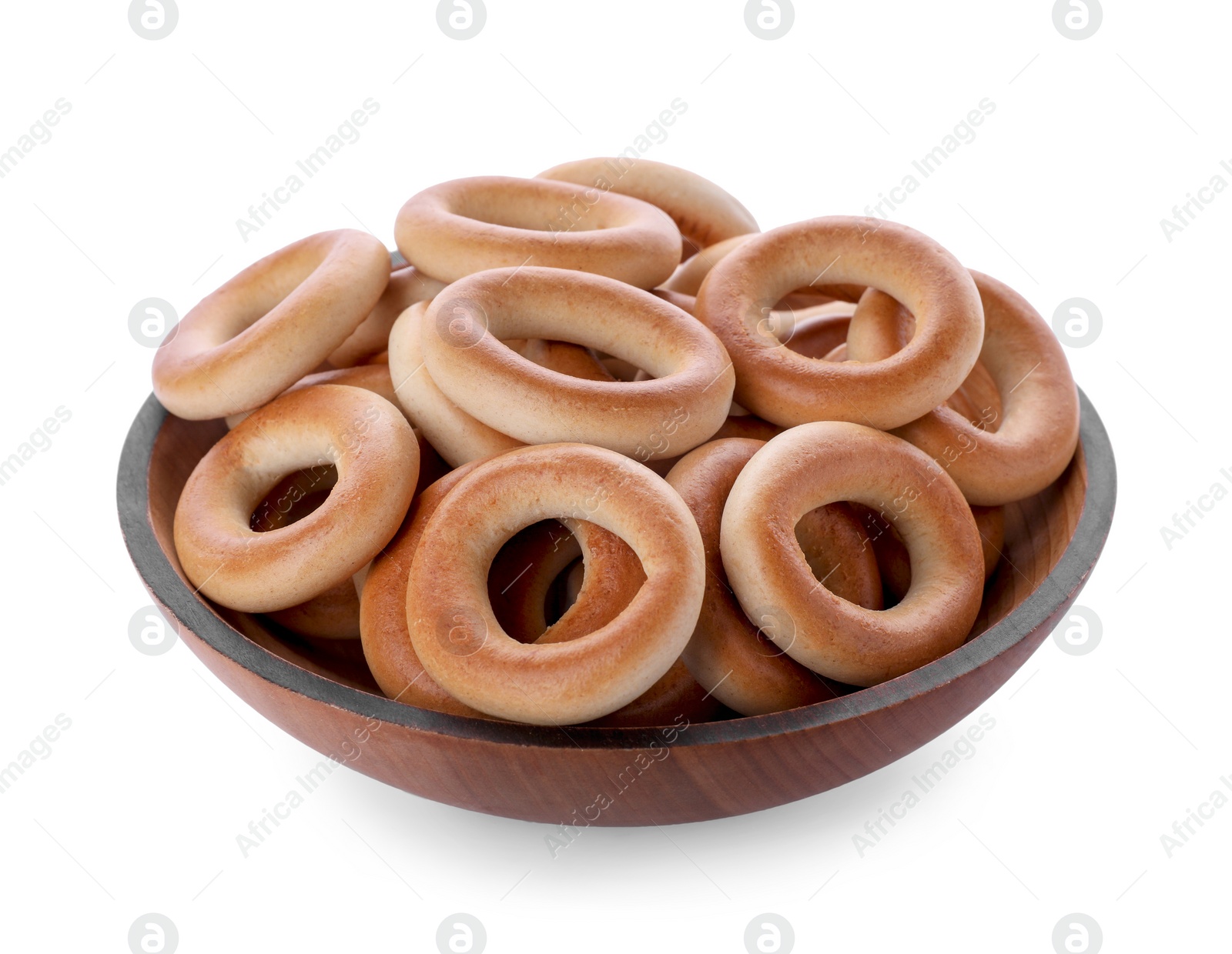 Photo of Wooden plate with tasty dry bagels (sushki) isolated on white