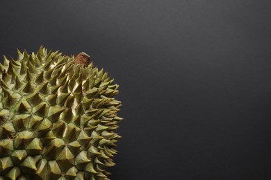 Photo of Fresh ripe durian on black background, closeup. Space for text