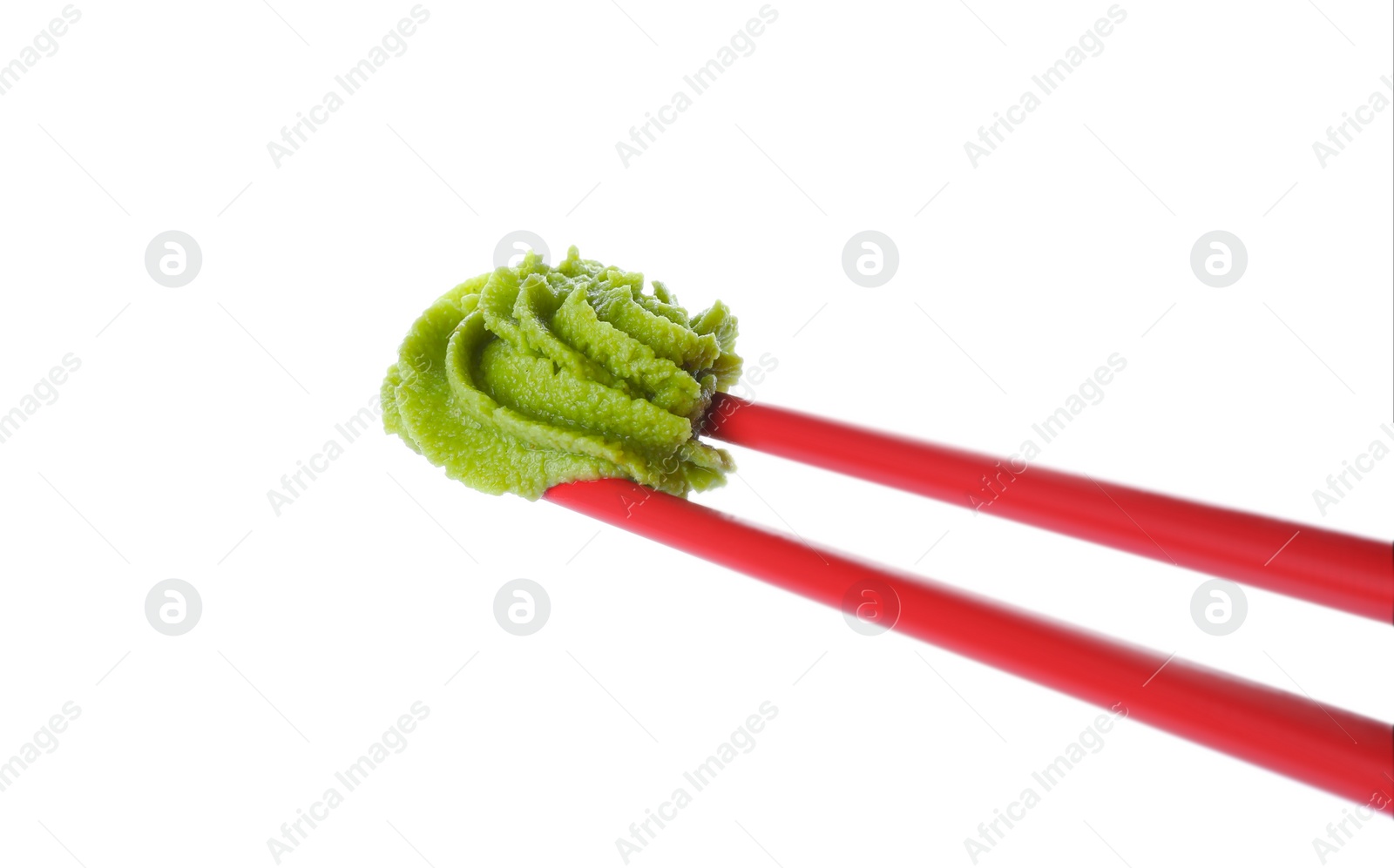 Photo of Chopsticks with swirl of wasabi paste isolated on white