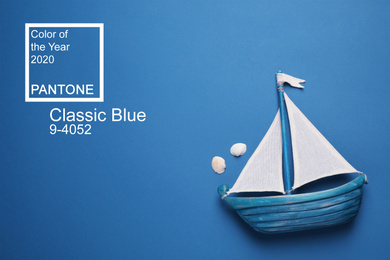 Image of Toy ship on bright background, top view. Color of the year 2020 (Classic blue)