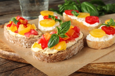 Tasty fresh tomato bruschettas on wooden board