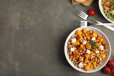 Photo of Delicious fresh chickpea salad served on grey table, flat lay. Space for text