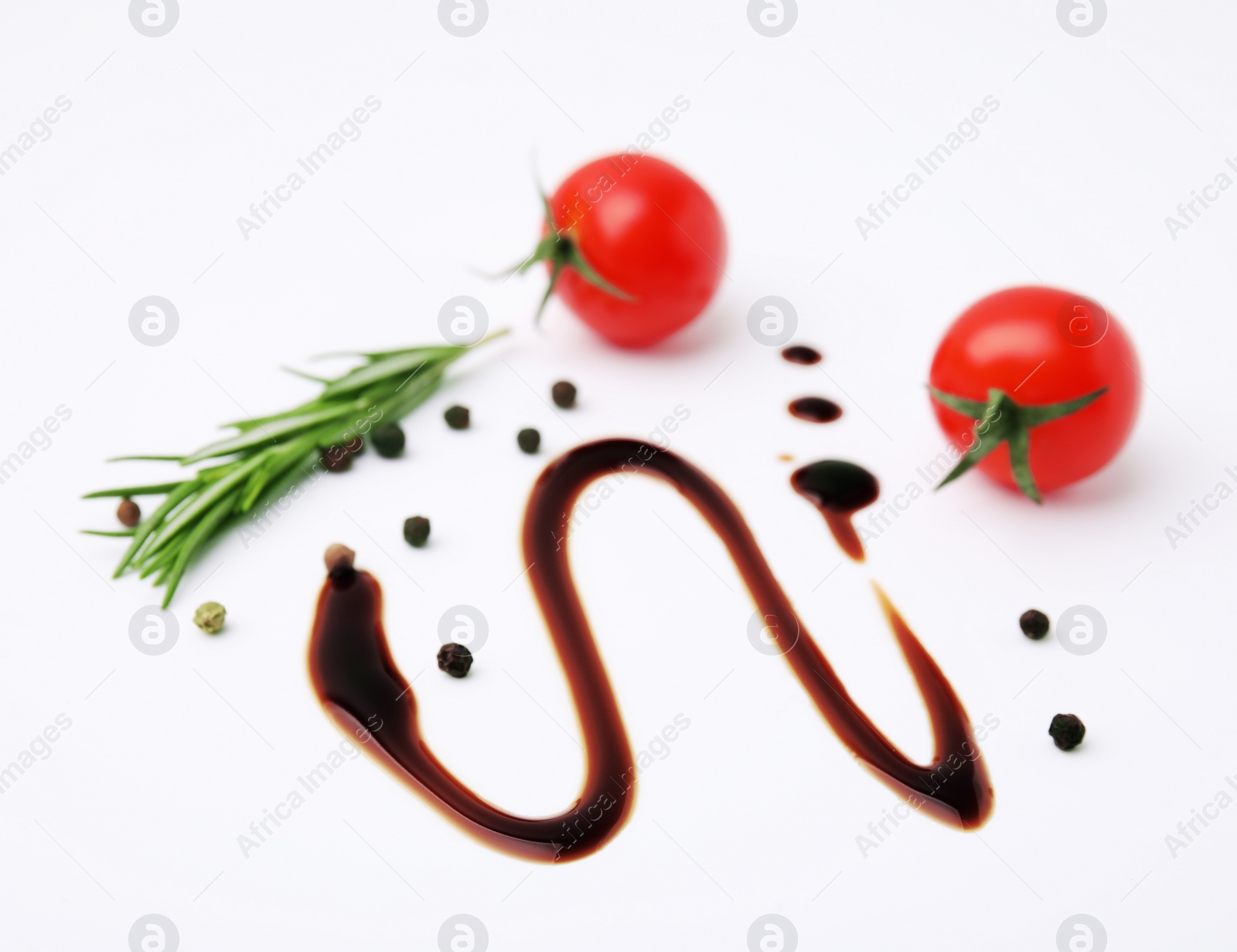 Photo of Organic balsamic vinegar and cooking ingredients on white background