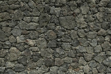 Photo of Texture of grey stone wall as background