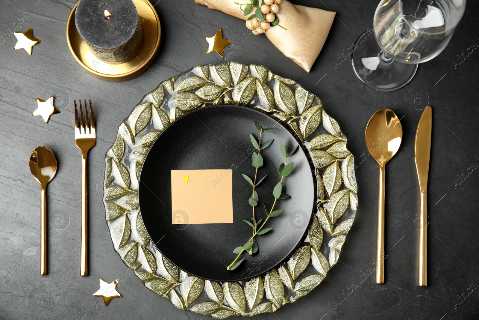 Photo of Elegant festive table setting with blank card on black background, flat lay