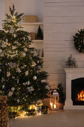 Photo of Stylish living room interior with decorated Christmas tree and fireplace