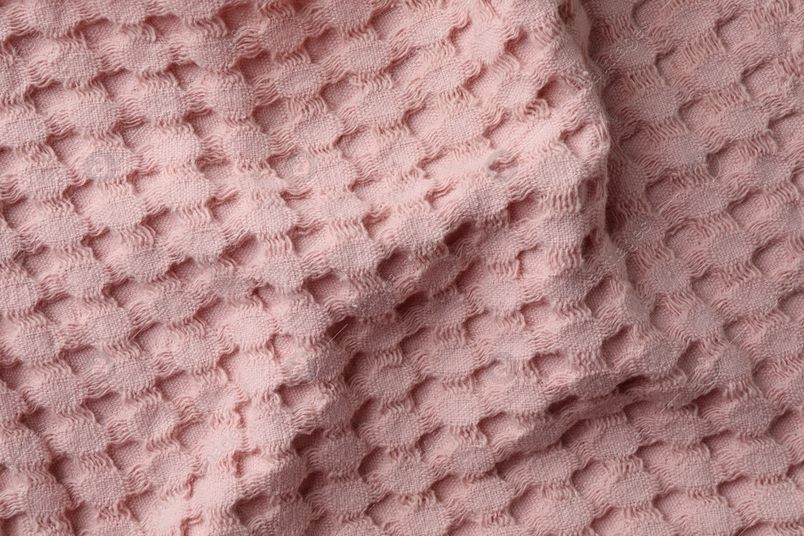 Photo of Texture of pink knitted fabric as background, top view