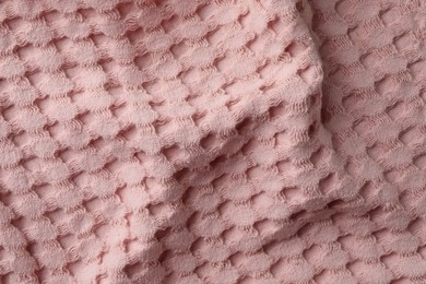 Photo of Texture of pink knitted fabric as background, top view