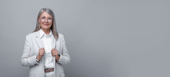 Image of Portrait of beautiful mature woman on light grey background. Banner design with space for text