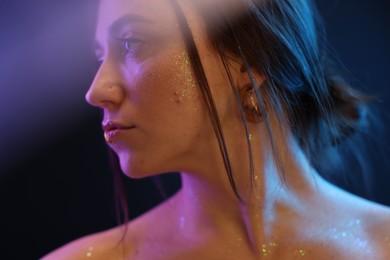 Photo of Portrait of beautiful woman on dark background in neon lights