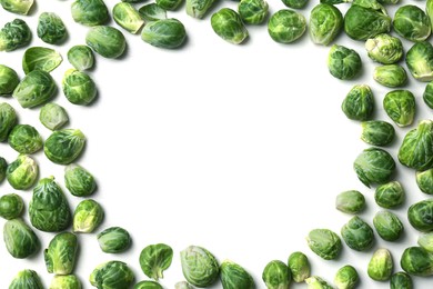 Frame of Brussels sprouts on white marble table, flat lay. Space for text