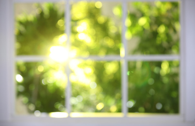 Blurred view through window on garden in morning