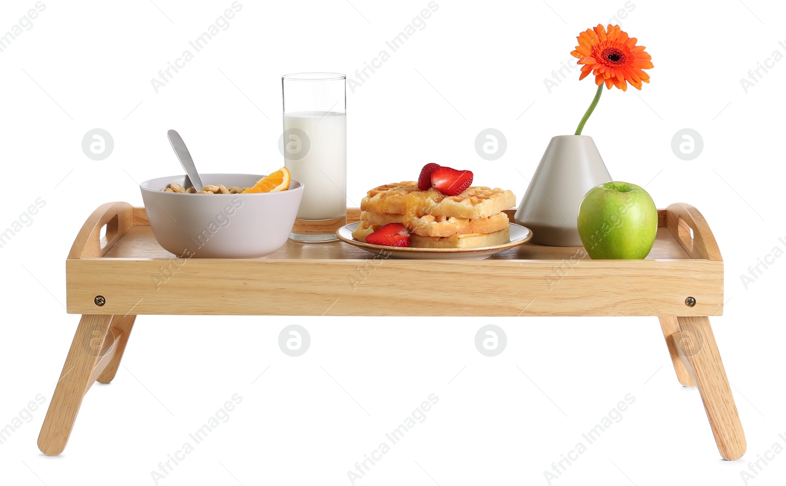 Photo of Wooden tray with delicious breakfast and beautiful flower on white background