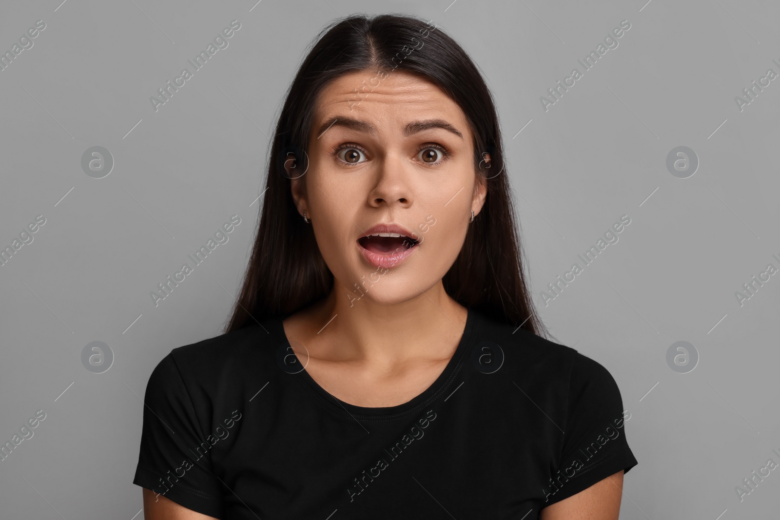 Photo of Personality concept. Emotional woman on grey background