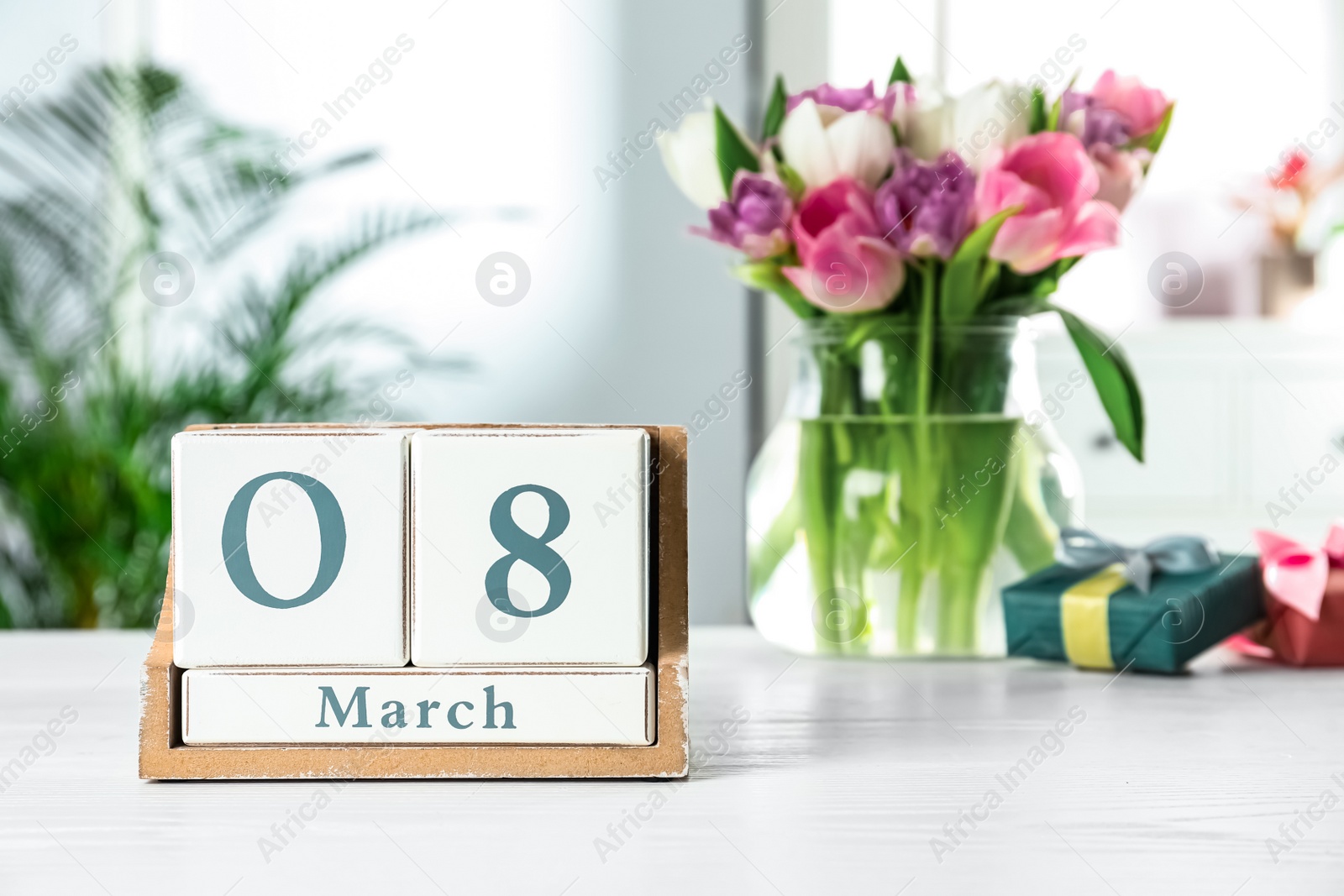 Photo of Wooden block calendar with date 8th of March on table indoors, space for text. International Women's Day