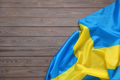 Photo of Flag of Sweden on wooden background, top view. Space for text