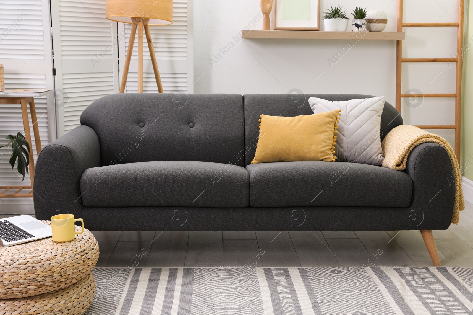 Photo of Stylish living room interior with comfortable sofa and lamp