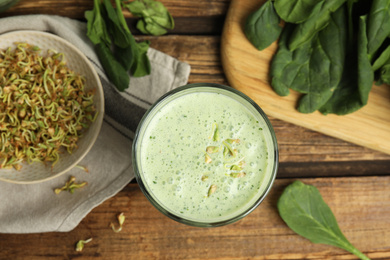 Flat lay composition with green buckwheat smoothie on wooden table